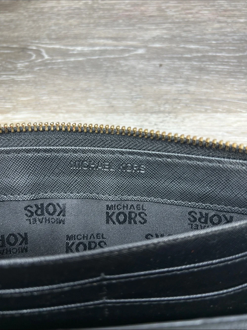 2828 Michael Kors Black Patent Leather Zip Wallet with Gold Plaque
